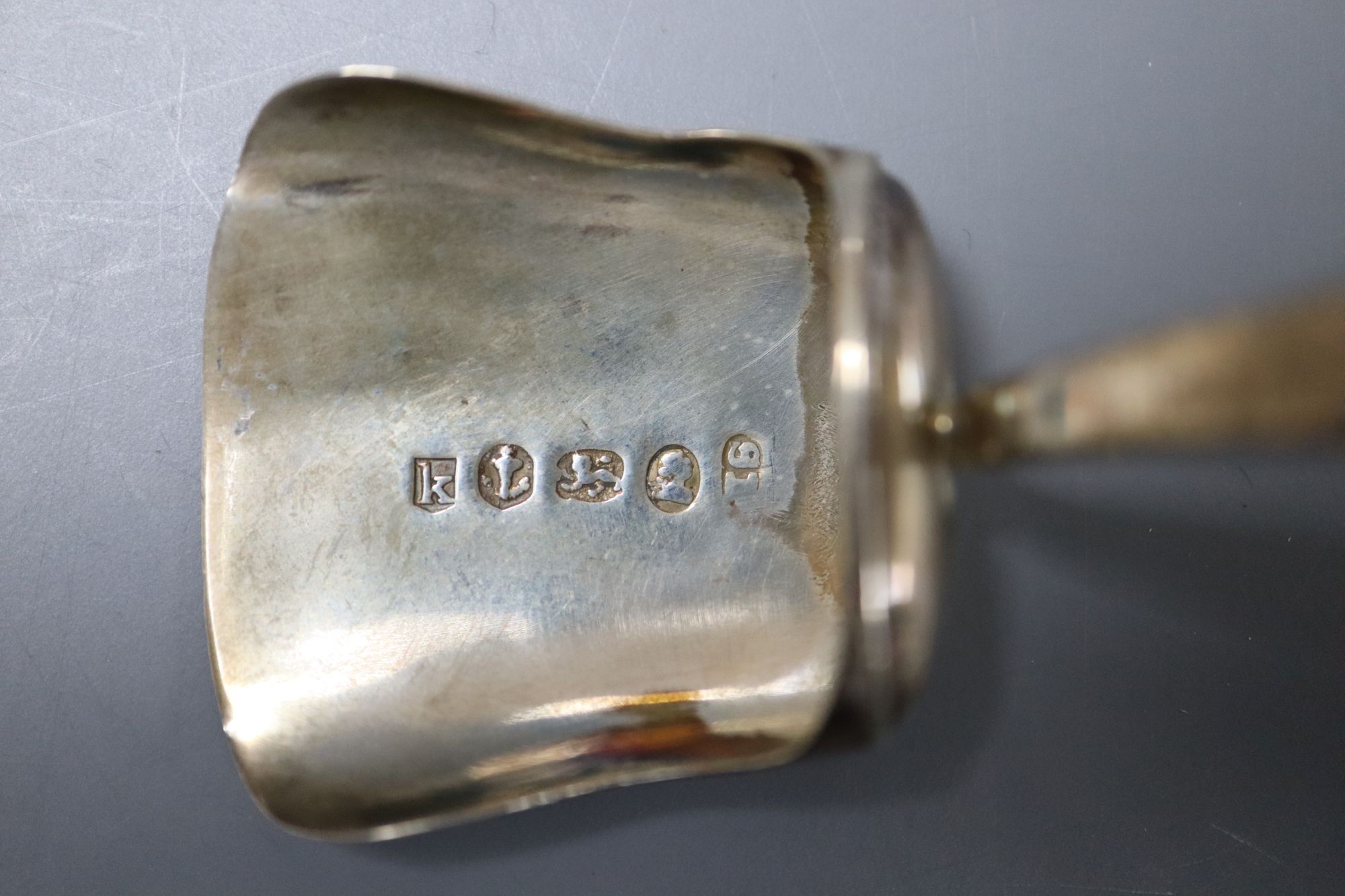 An early 18th century Dutch white metal spoon, the bowl underside monogrammed TIS-KLD and two silver caddy spoons.